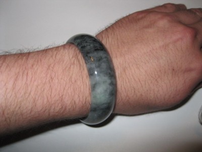 jade bangle worn on left wrist